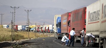 les chauffeurs se reposent près de leurs camions transportant des marchandises en Irak à la frontière Turque mercredi.